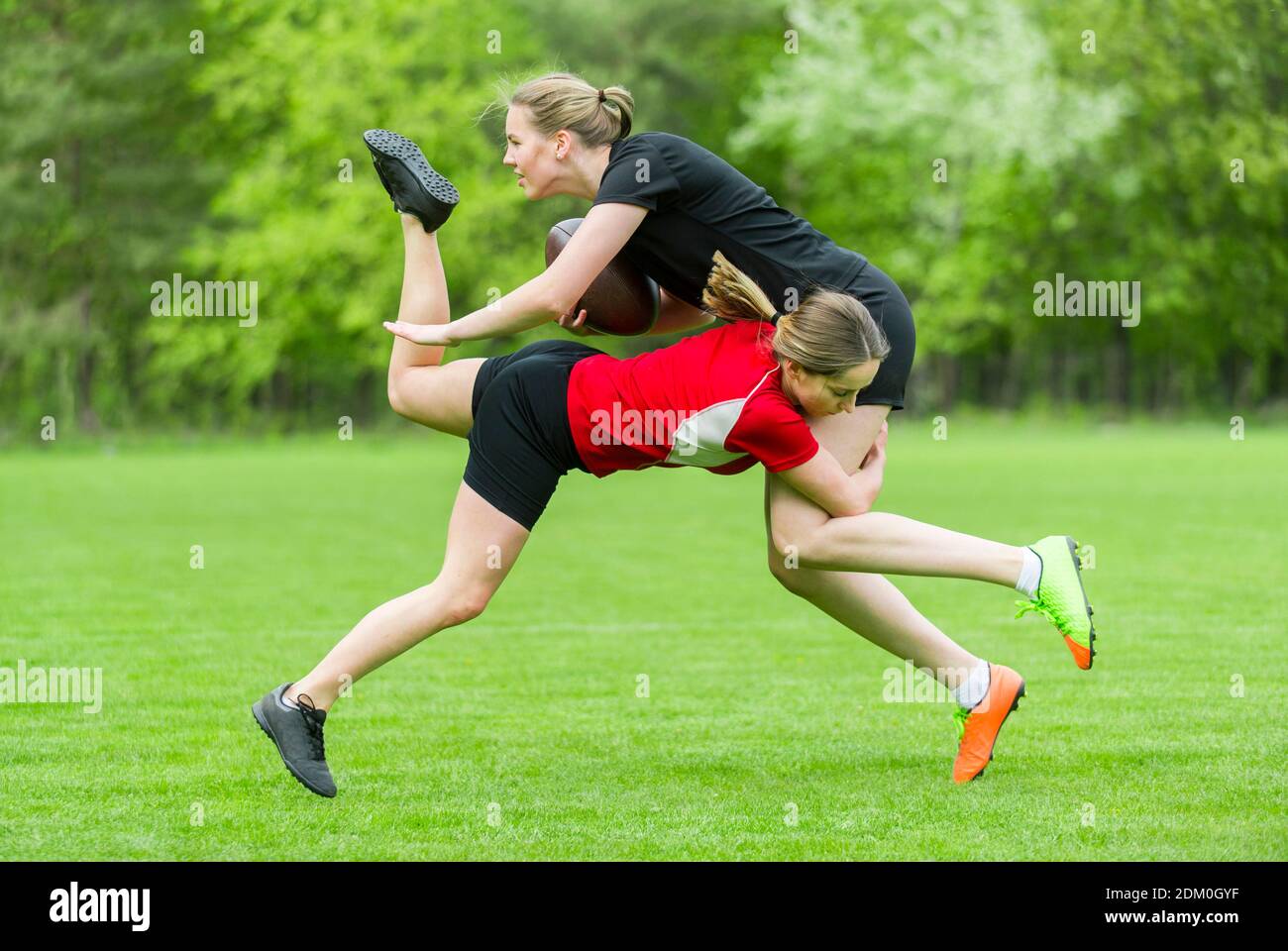 Female Rugby Player Tackling Opponent On Playing Field Stock Photo Alamy