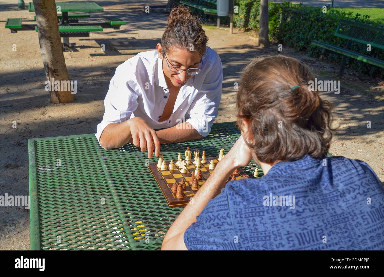 A closeup shot of a young man playing chess in the park Stock Photo
