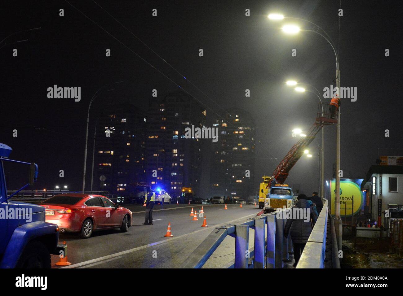 Kyiv, Ukraine. 15th Dec, 2020. Police controls the traffic on Shuliavsky bridge in Kyiv.On the repaired Shuliavsky bridge in Kyiv, three lighting columns fell at once as a result, nine cars were damaged, and the roads were jammed in Kyiv. Credit: SOPA Images Limited/Alamy Live News Stock Photo