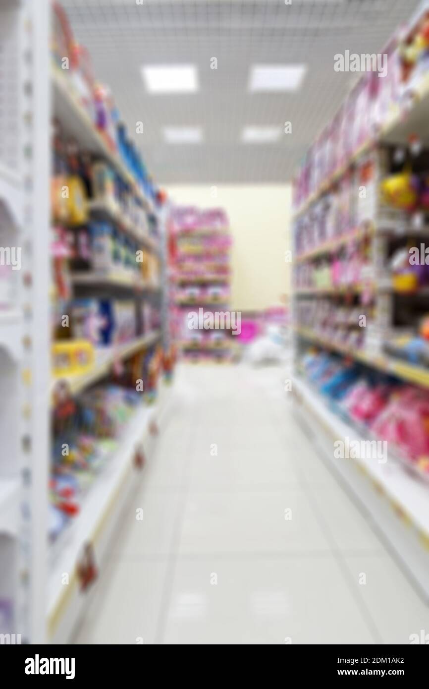 Abstract vertical blurred and defocused image of supermarket or shopping mall for background, backdrop or backcloth. Stock Photo