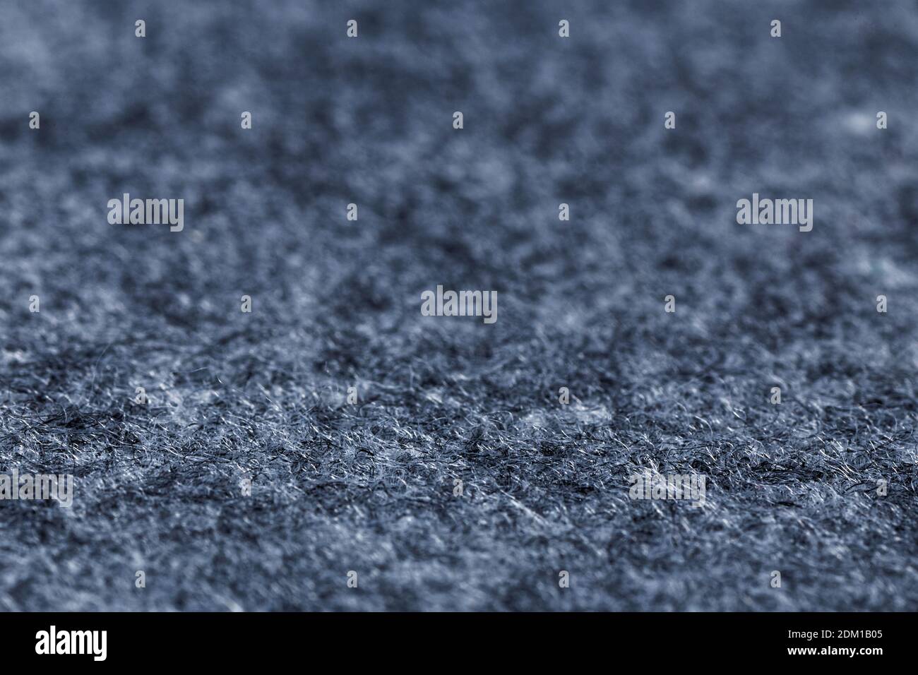 Closeup artificial grey felt background. Angle view. Shallow focus. Stock Photo