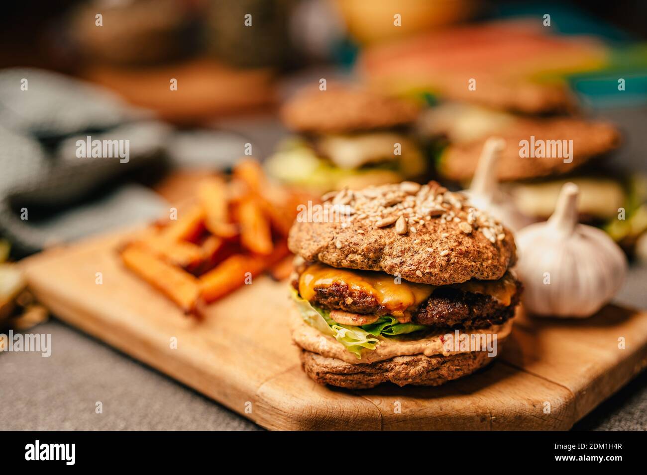 Homemade low carb diet hamburger with seed flour buns and pumpkin fries.Diet burgers with sugar-free sauce, mayonnaise, lettuce, and melted cheese.Bee Stock Photo