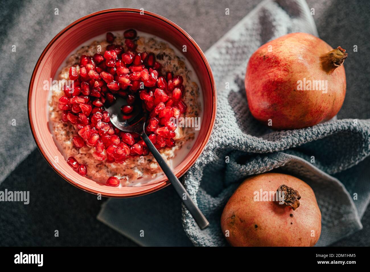 Homemade low carb diet almond and coconut flakes porridge with red pomegranate seeds.Morning light.Healthy organic nutritious vegan breakfast.Chia see Stock Photo