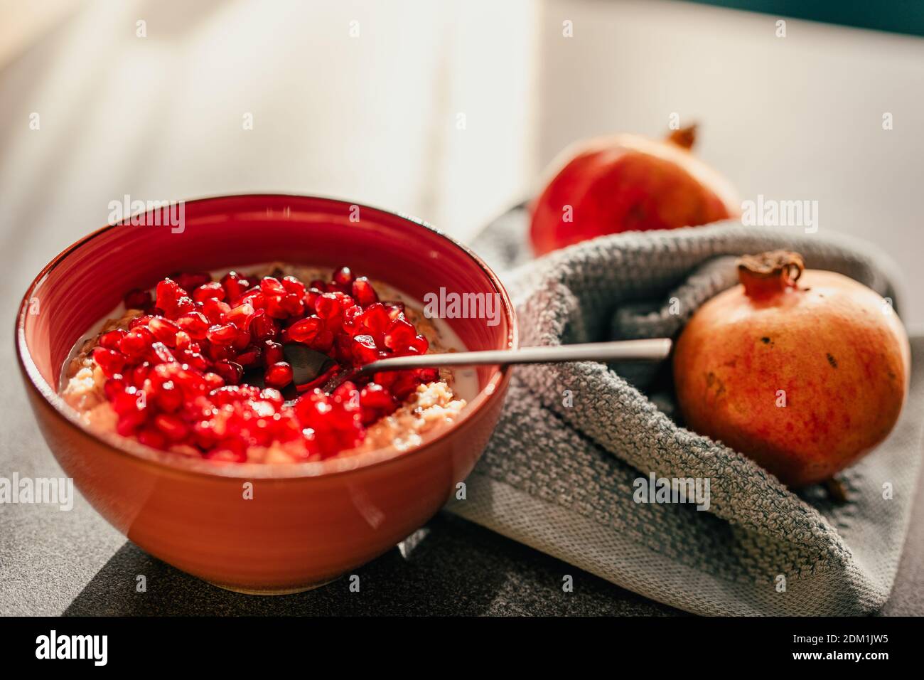 Homemade low carb diet almond and coconut flakes porridge with red pomegranate seeds.Morning light.Healthy organic nutritious vegan breakfast.Chia see Stock Photo