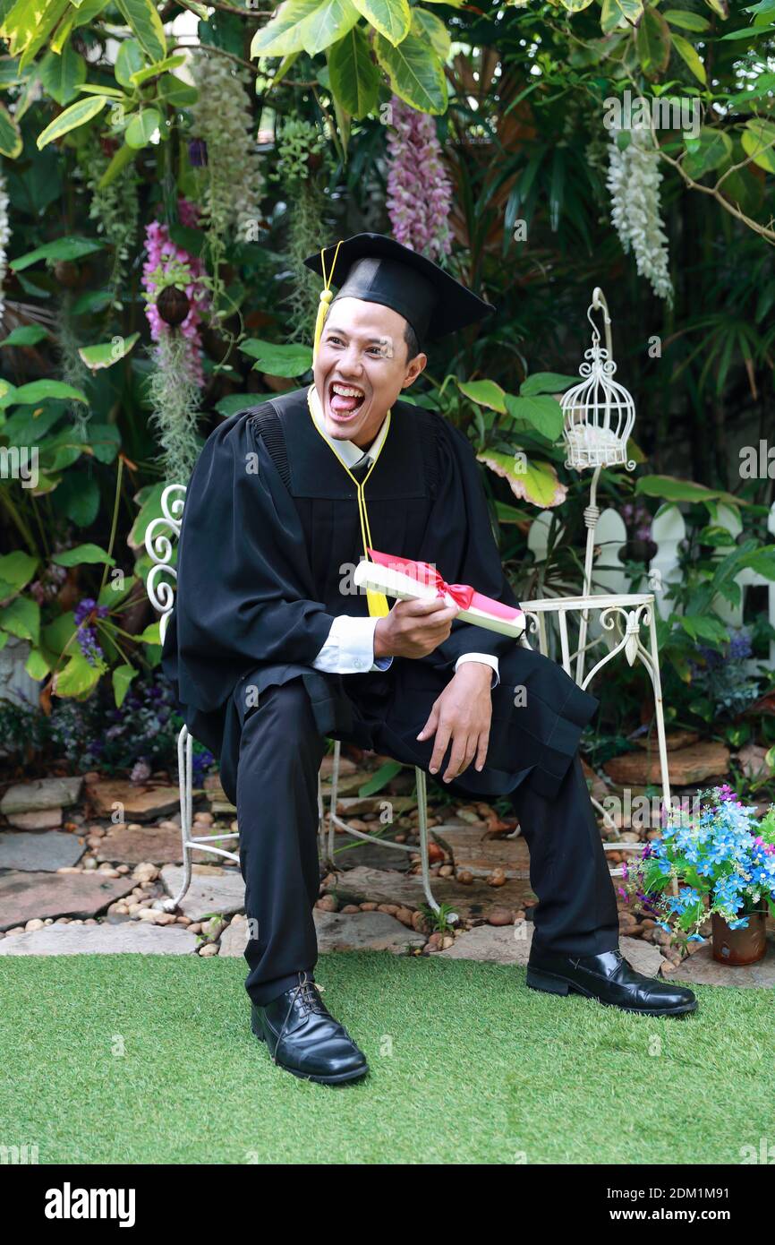 Man sitting in front of diploma hi-res stock photography and images - Alamy