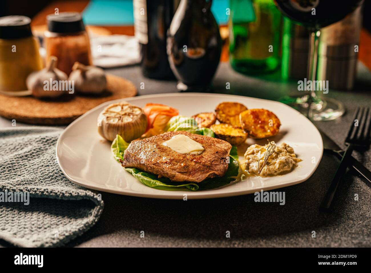 Served plate of seared tenderloin steak with side of baked baby potatoes and garlic dip.Filet mignon dinner for special occasion and home celebration. Stock Photo