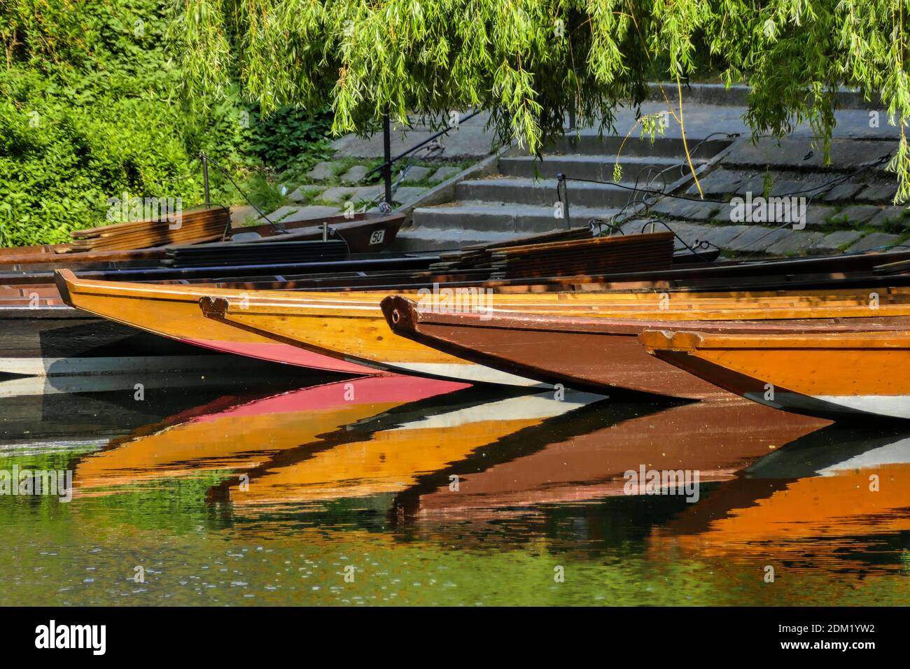 The reflection of colorful boats on the surface of a lake Stock Photo ...