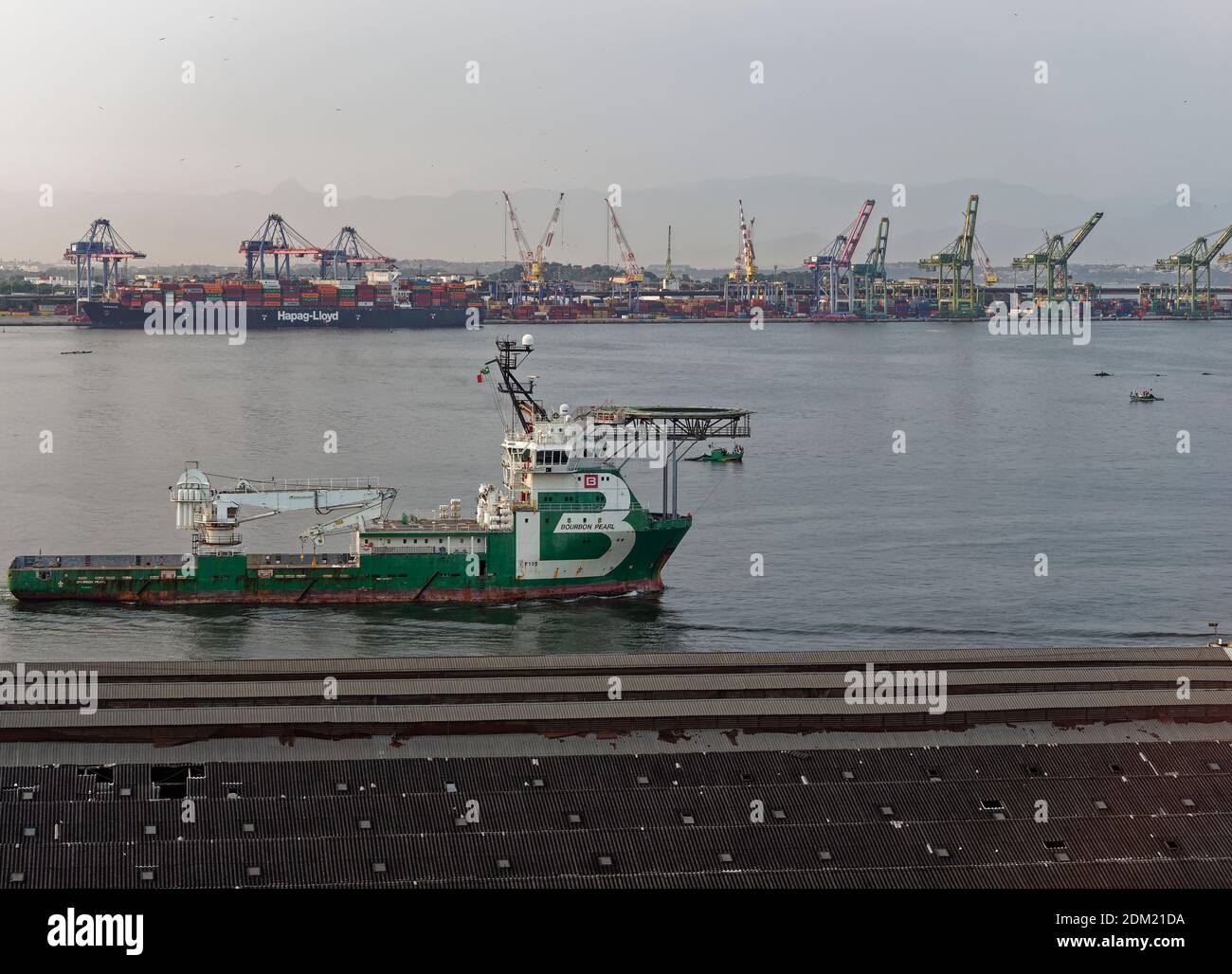 The Bourbon Pearl departing the Old Port of Rio, the Porto Maravilha, with a Container Ship moored alongside in the background. Stock Photo