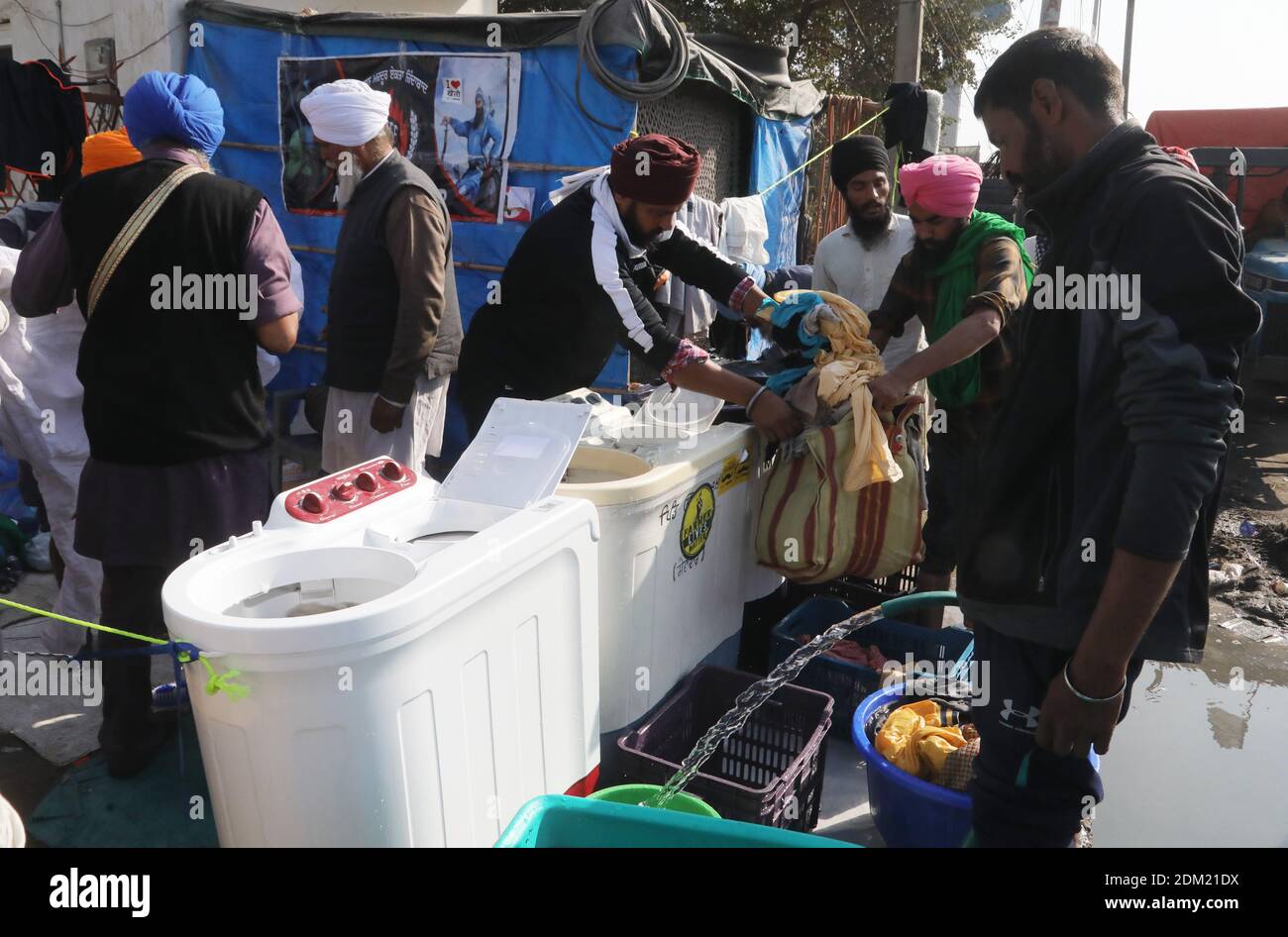 Protesters washing clothes during the demonstration.Thousands of Farmers protest for 21days on different borders linked to New Delhi demanding the rollback of 3 government agricultural reforms bill. Stock Photo
