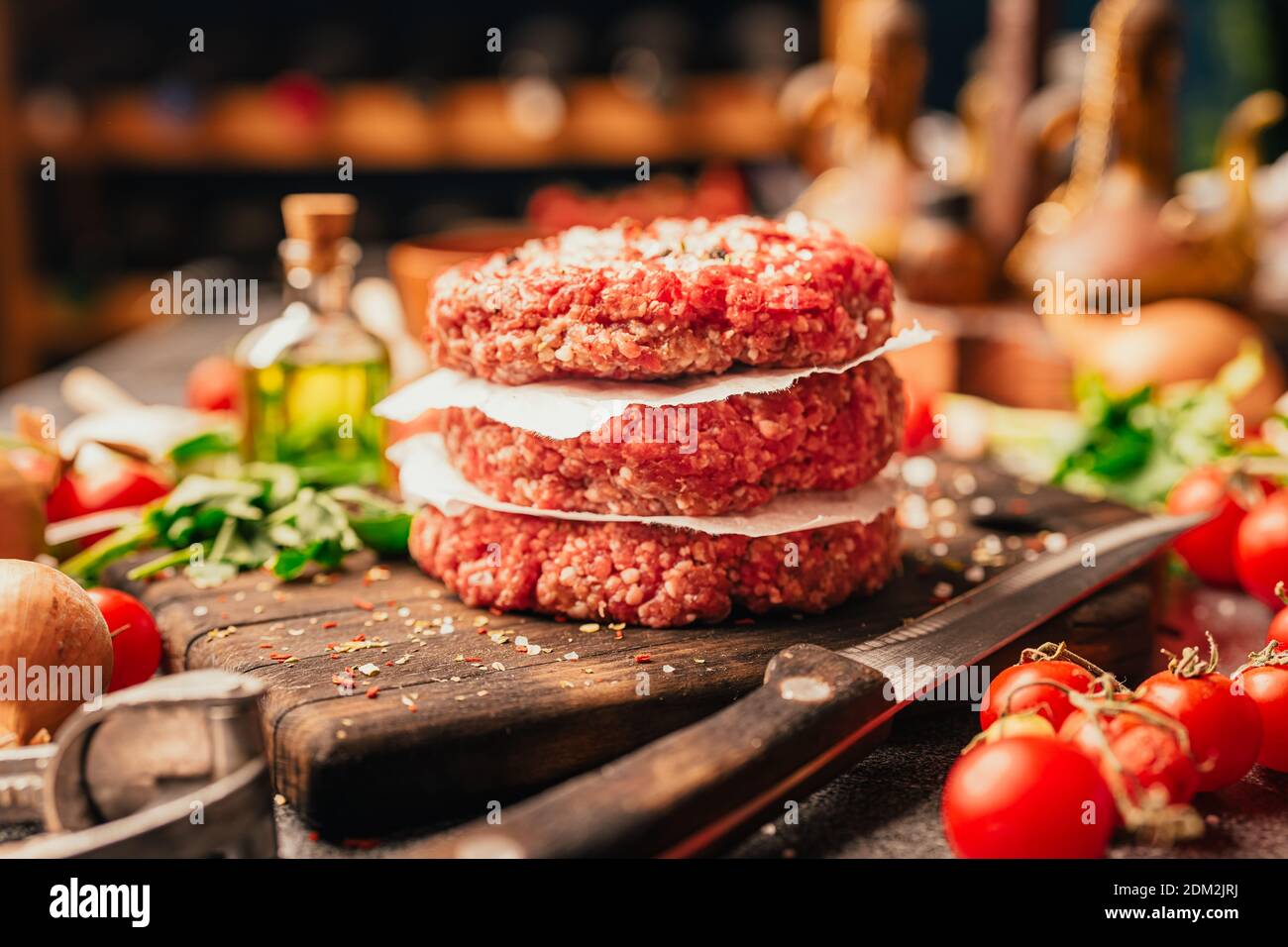 Round ground beef portioned beef patties made from beef mince prepared for on a platter.Hamburger meat seasoned and ready for a barbecue.Spices and co Stock Photo