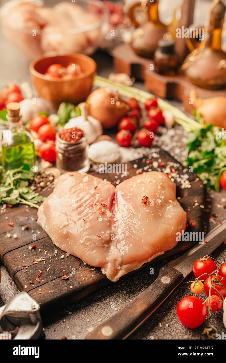 Fresh skinless chicken breast from organic poultry farm prepared for cooking homemade recipe.White meat diet.Protein food consumption.Seasoning and co Stock Photo