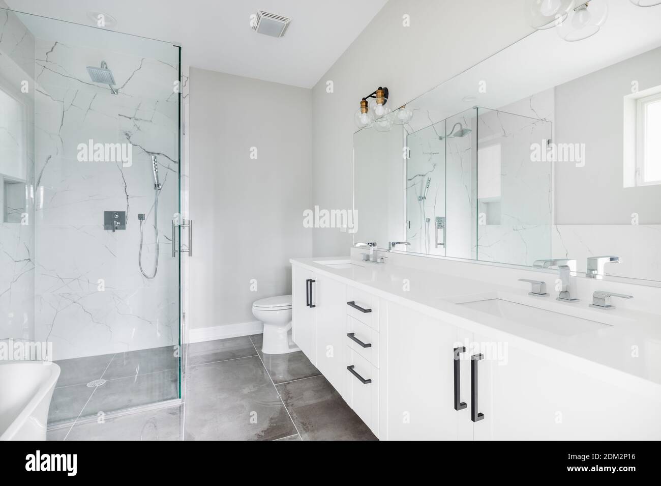 A modern, white luxury bathroom with black hardware and chrome faucets