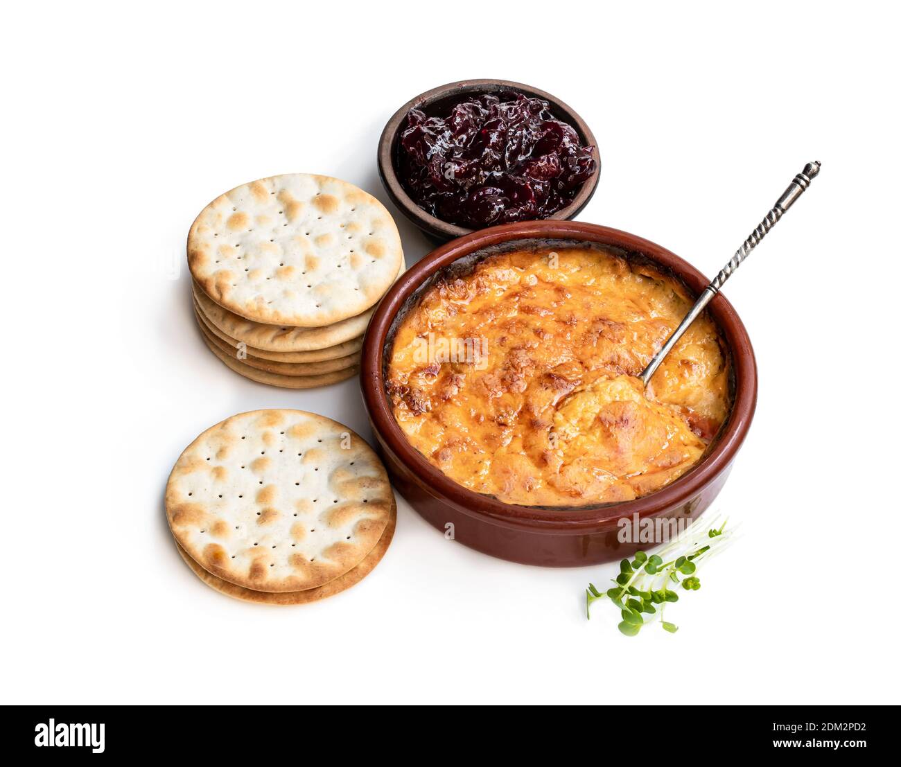 Baked mature cheddar cheese with spanish chorizo isolated on white