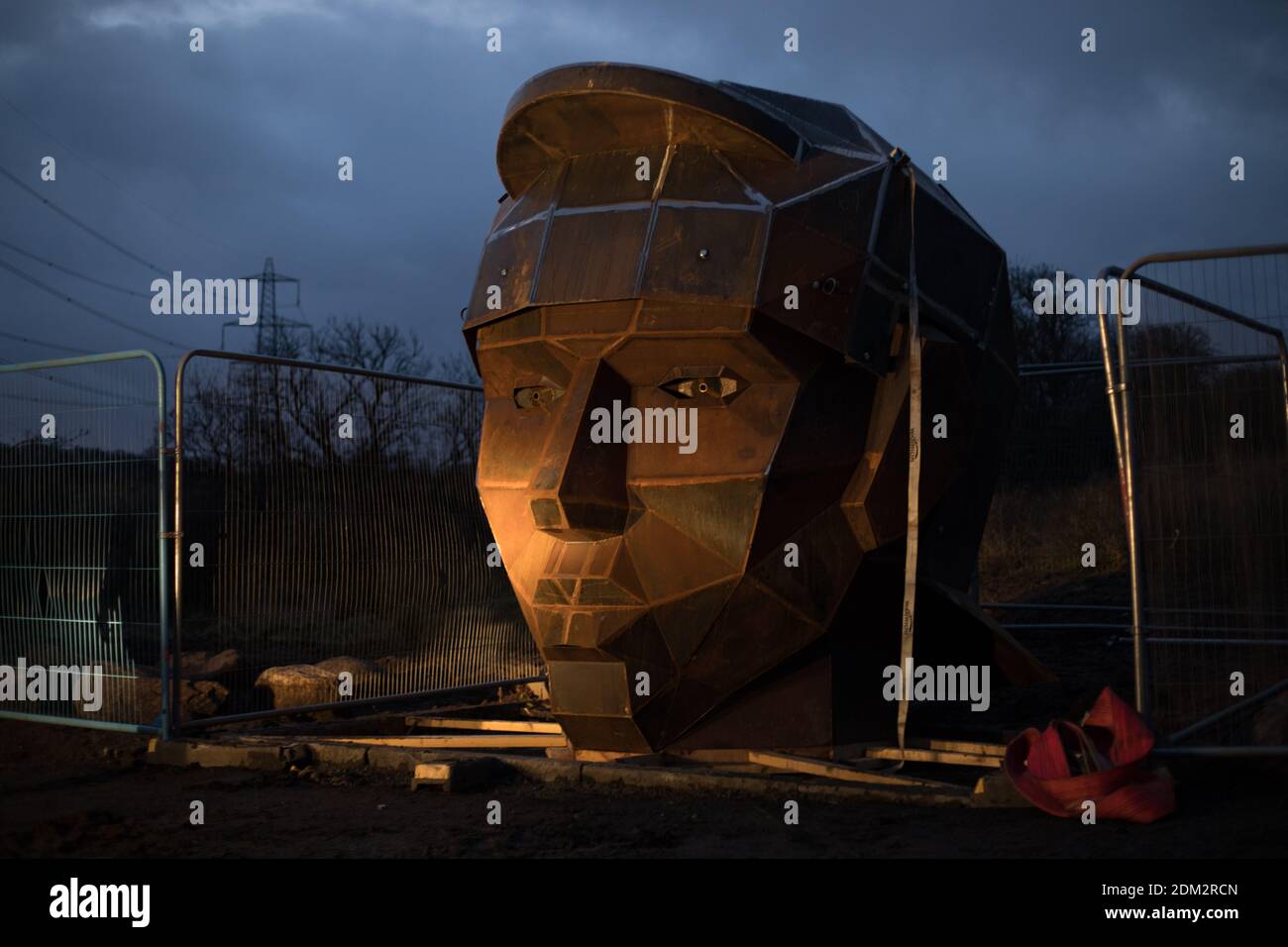 Nethercroy, Scotland, UK, 16th December 2020. Work continues on the installation of a 6-metre sculpture, by artist Svetlana Kondakova, of a Roman soldier's head, nick-named Silvanus - after the Roman God protector of fields, forest and cattle, and a name which chosen by a public vote, at the Nethercroy site on the route of the Roman-era Antonine Wall. The sculpture, built by Big Red Blacksmiths, was commissioned as part of a wider 'Rediscovering the Antonine Wall' project. Working across central Scotland the project aims to build better connections for communities and visitors along the length Stock Photo