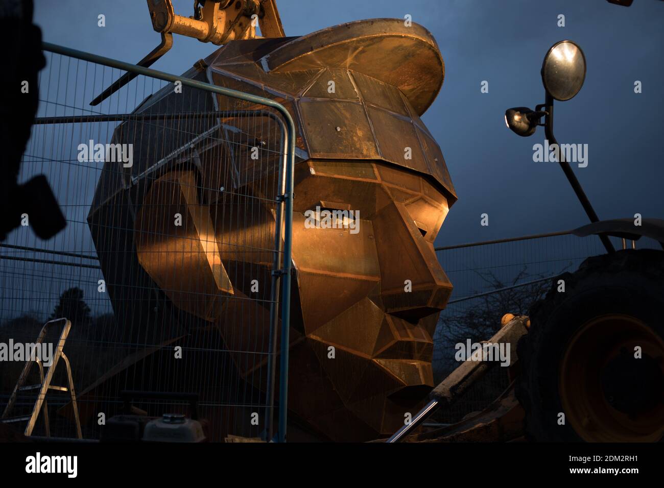 Nethercroy, Scotland, UK, 16th December 2020. Work continues on the installation of a 6-metre sculpture, by artist Svetlana Kondakova, of a Roman soldier's head, nick-named Silvanus - after the Roman God protector of fields, forest and cattle, and a name which chosen by a public vote, at the Nethercroy site on the route of the Roman-era Antonine Wall. The sculpture, built by Big Red Blacksmiths, was commissioned as part of a wider 'Rediscovering the Antonine Wall' project. Working across central Scotland the project aims to build better connections for communities and visitors along the length Stock Photo