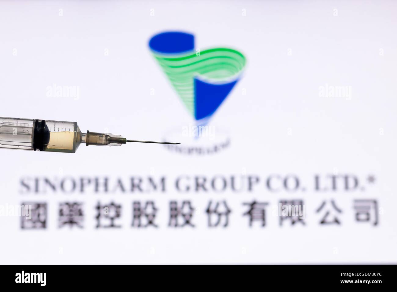 Kathmandu, Nepal - December 15 2020: Closeup of Syringe Injection full of vaccine against Sinopharm Logo. Stock Photo