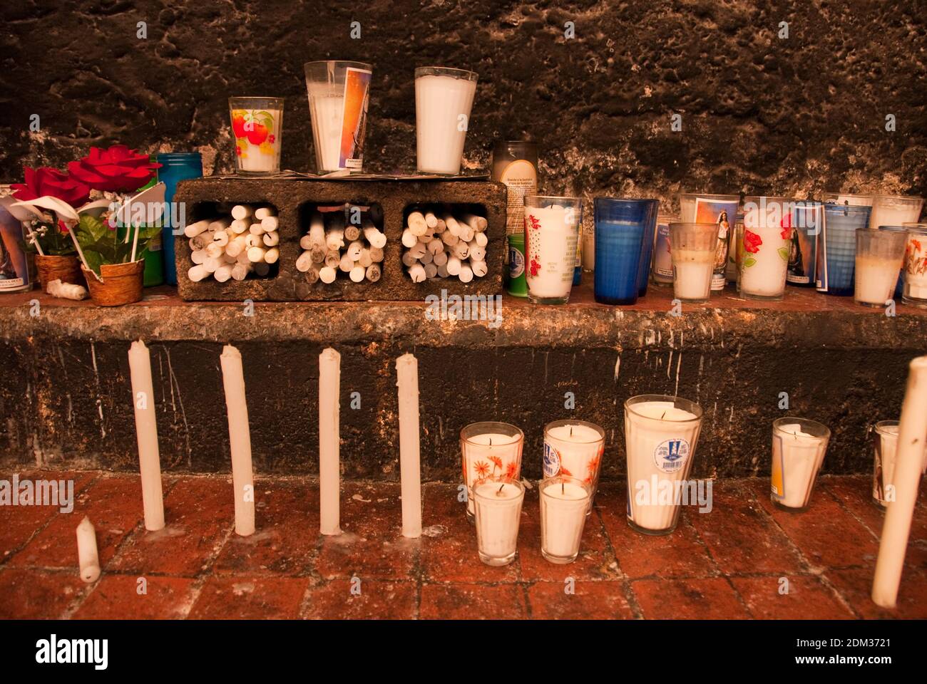 Votive candles and photographs on an altar at the Convento de San