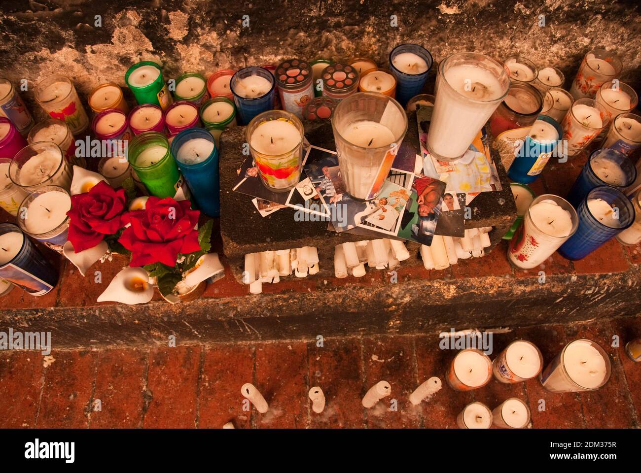 Votive candles and photographs on an altar at the Convento de San