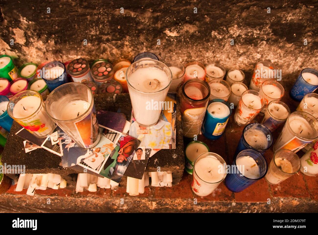 Votive candles and photographs on an altar at the Convento de San