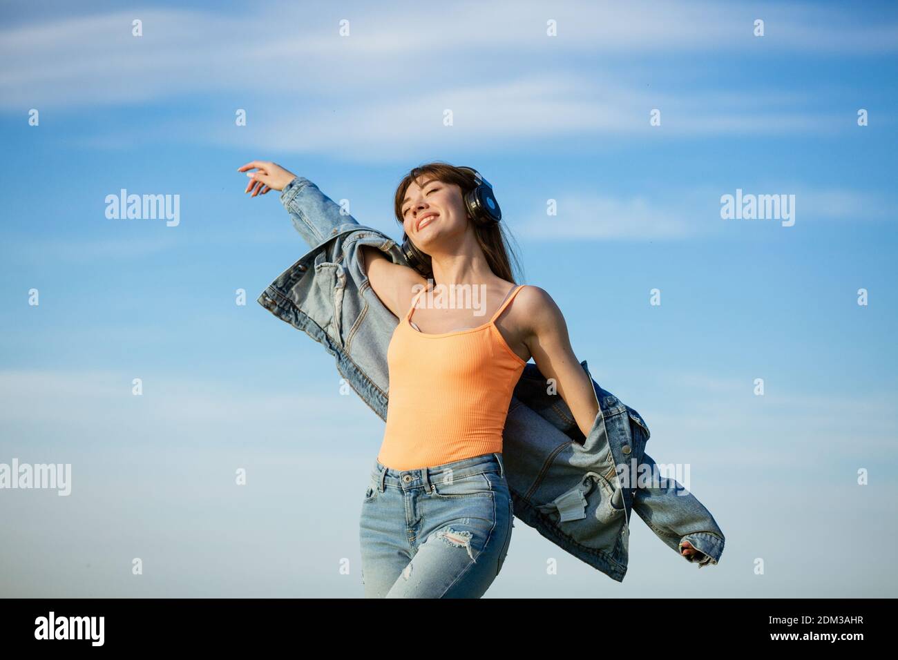 Woman dancing beach jeans hi-res stock photography and images - Alamy