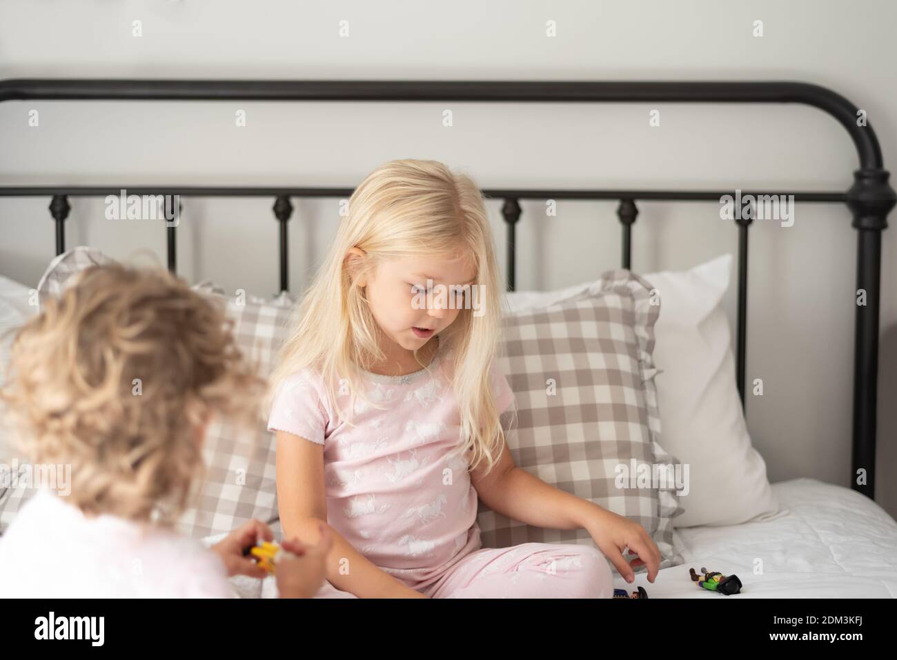Happy Girl Sitting On Floor Stock Photo - Alamy
