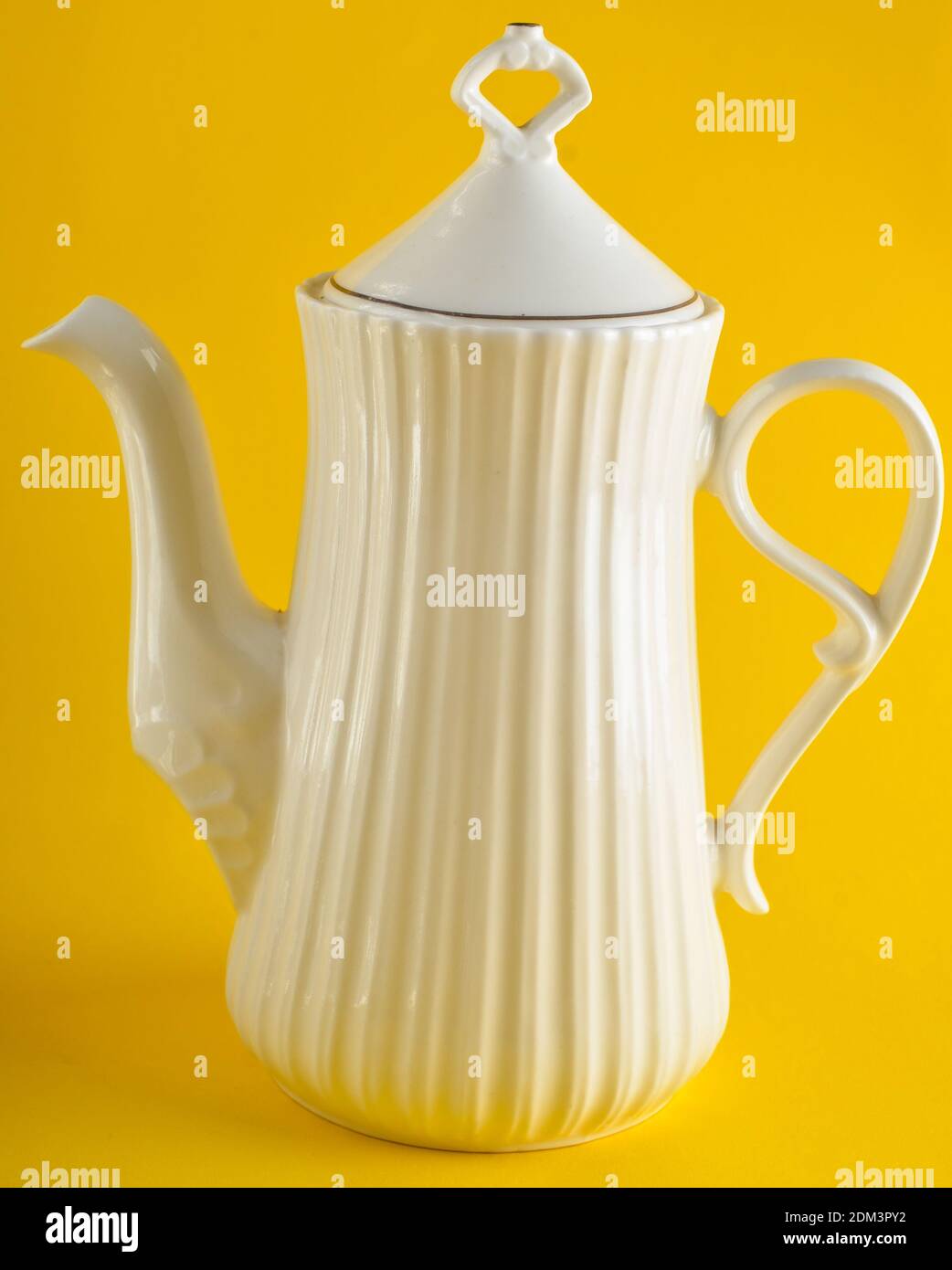 Ceramic white teapot on a yellow background Stock Photo Alamy