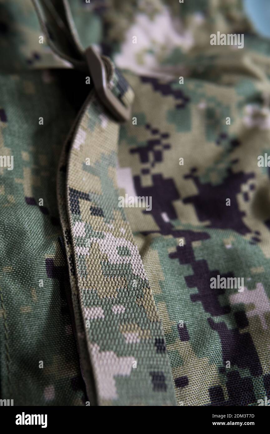 A vertical closeup shot of camouflage military gear Stock Photo