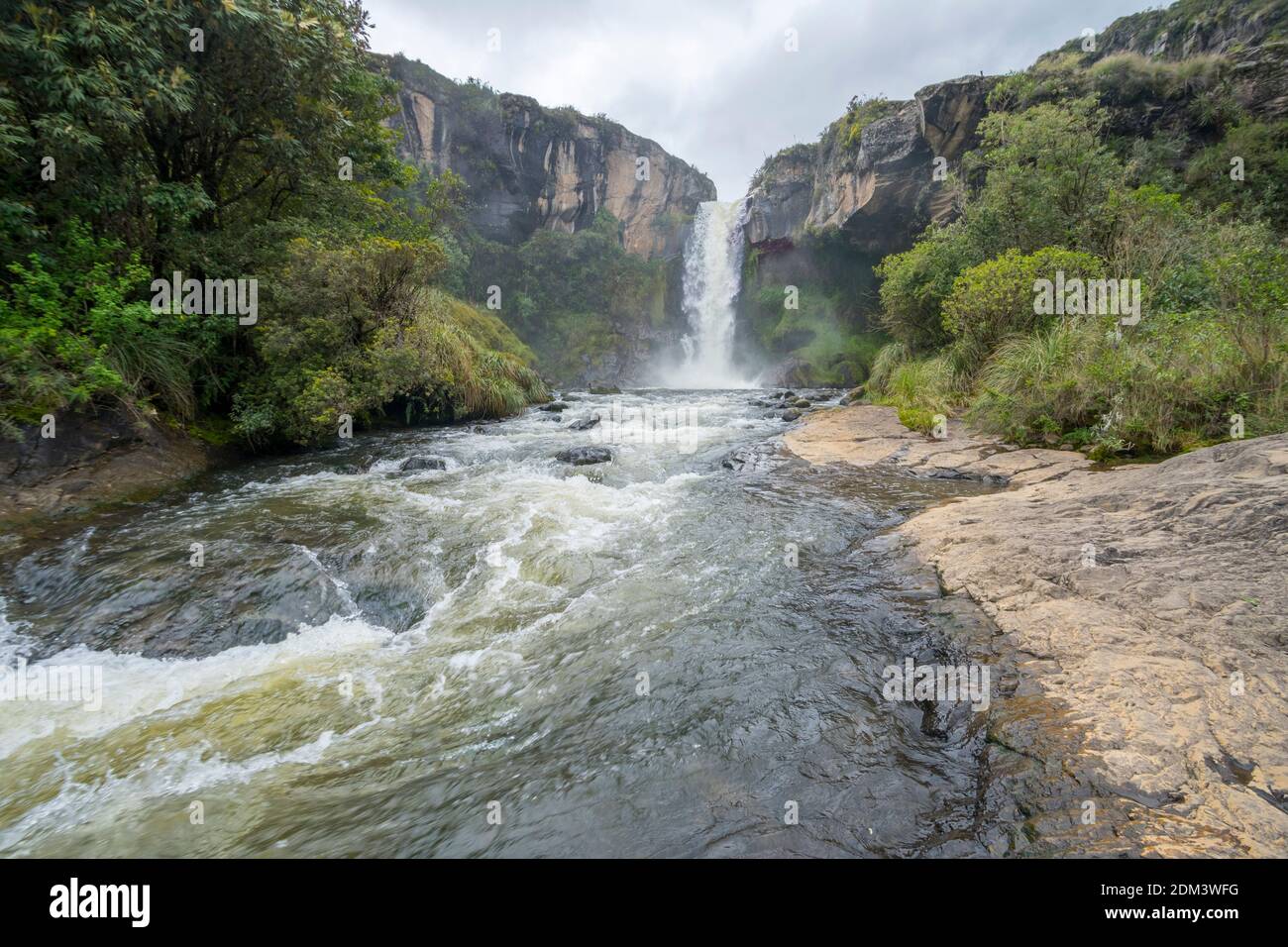 Waterfall in the Rio Pita Valley near Cotopaxi Volcano running off a cliff comprised of an old lava flow. In the Ecuadorian Andes Stock Photo