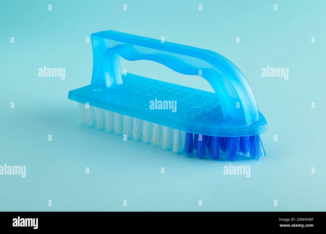 Blue plastic brush for house cleaning on a blue background Stock Photo ...