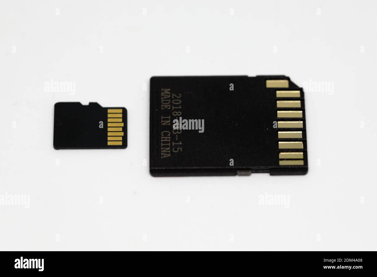 A micro SD  card  and its adapter showing its under side and contacts Stock Photo