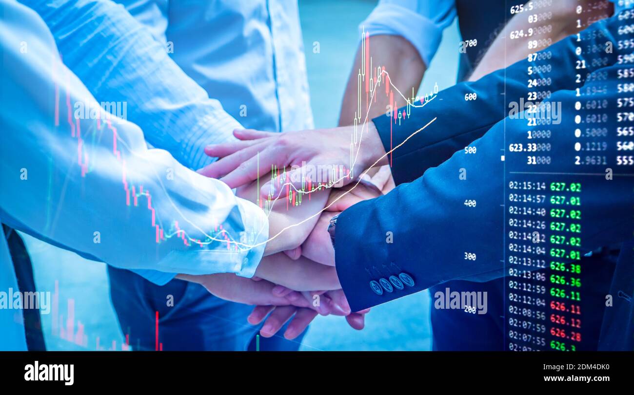 Digital Composite Image Of Business People Stacking Hands With Graph Stock Photo