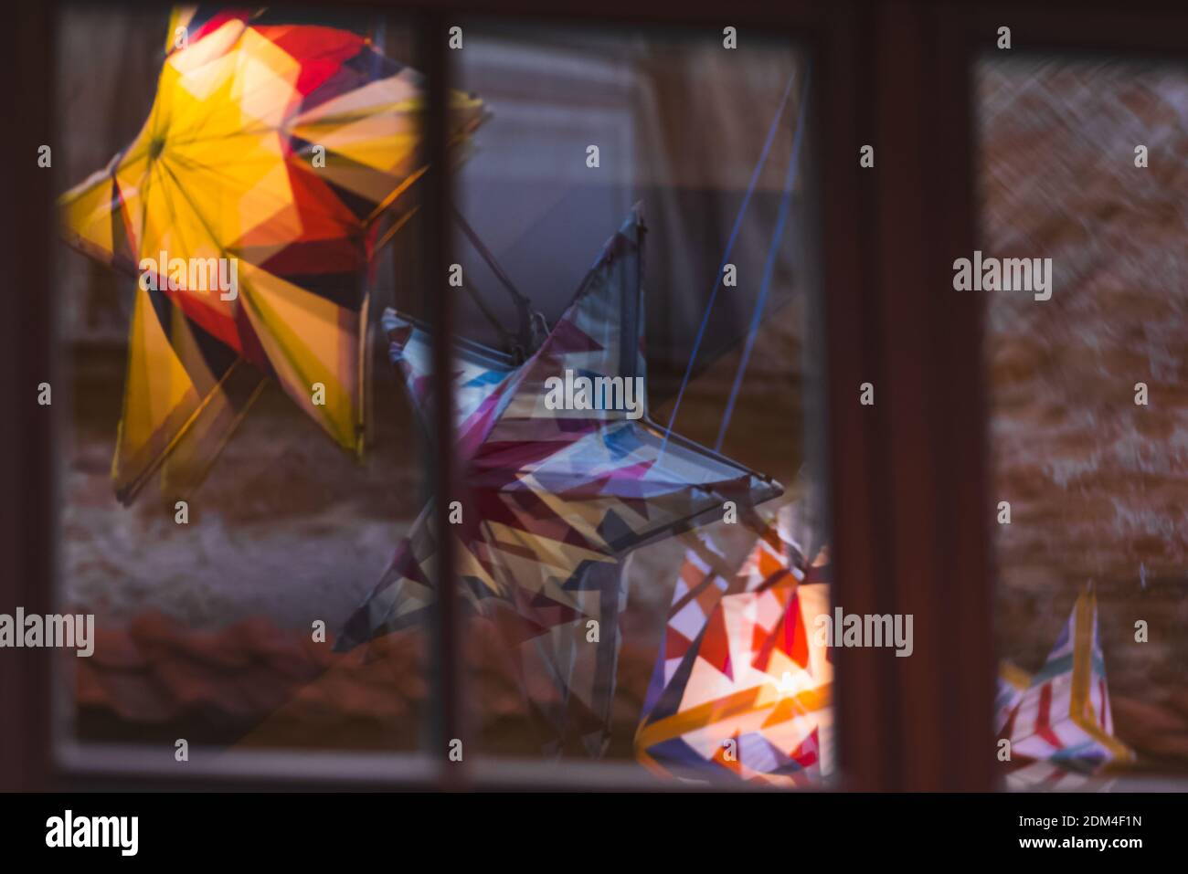 Lublin, Poland - December 29, 2019: Colorful illuminated stars reflecting in building window at Złota Street in old town Stock Photo