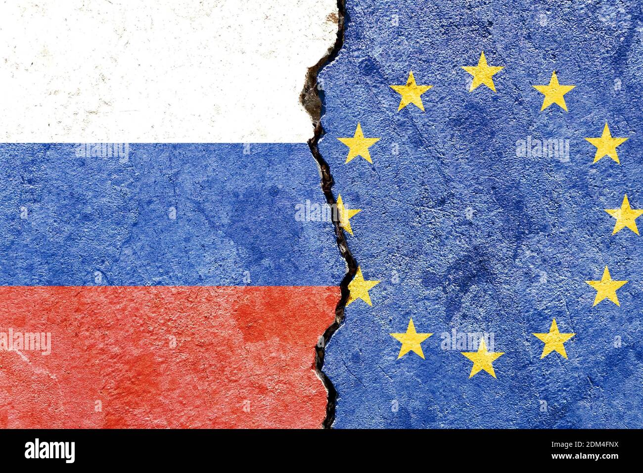 A Russian and EU flag on a cracked wall- politics, war, conflict concept Stock Photo