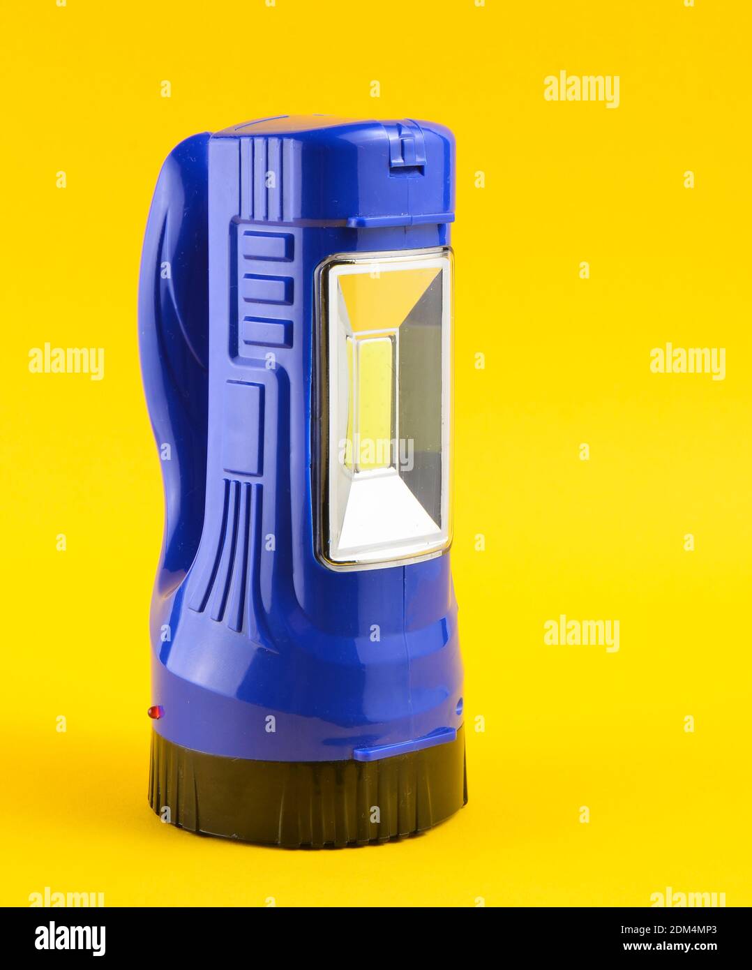 Flashlight Blue Color Blue flashlight isolated on a yellow background Stock Photo - Alamy