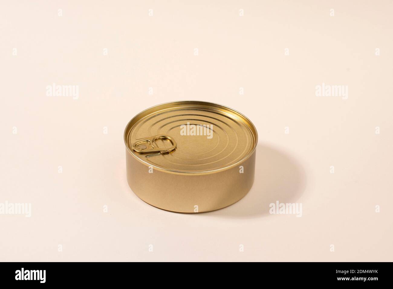 Gold unlabeled tin can on light background Stock Photo