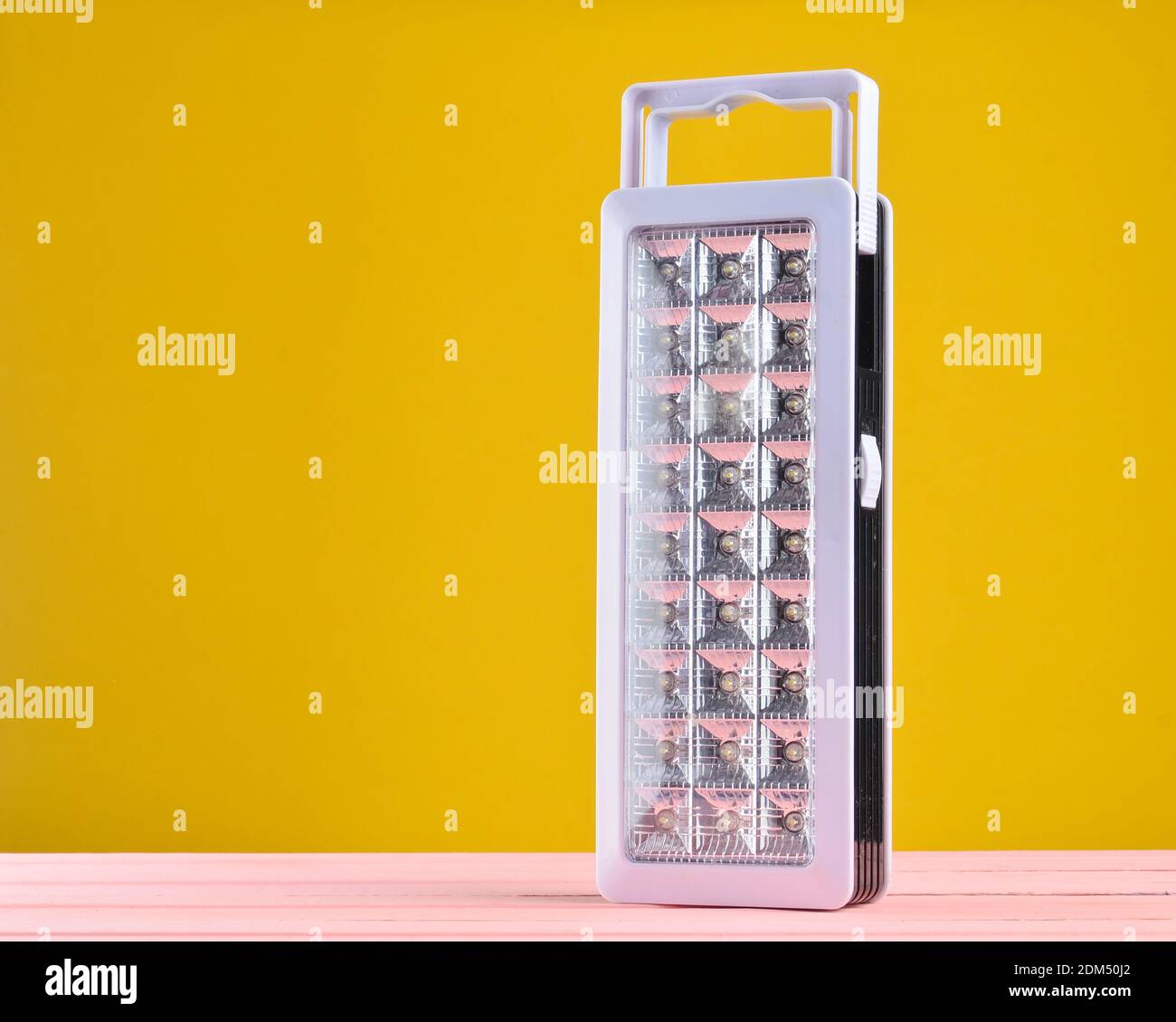 Plastic led flashlights on yellow background Stock Photo