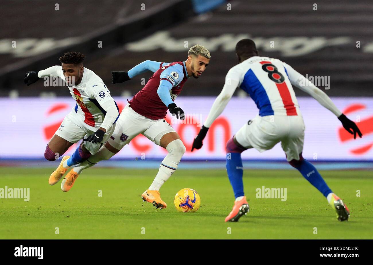 West Ham United's Said Benrahma and Crystal Palace's Wilfried Zaha (left) battle for the ball during the Premier League match at the London Stadium. Stock Photo
