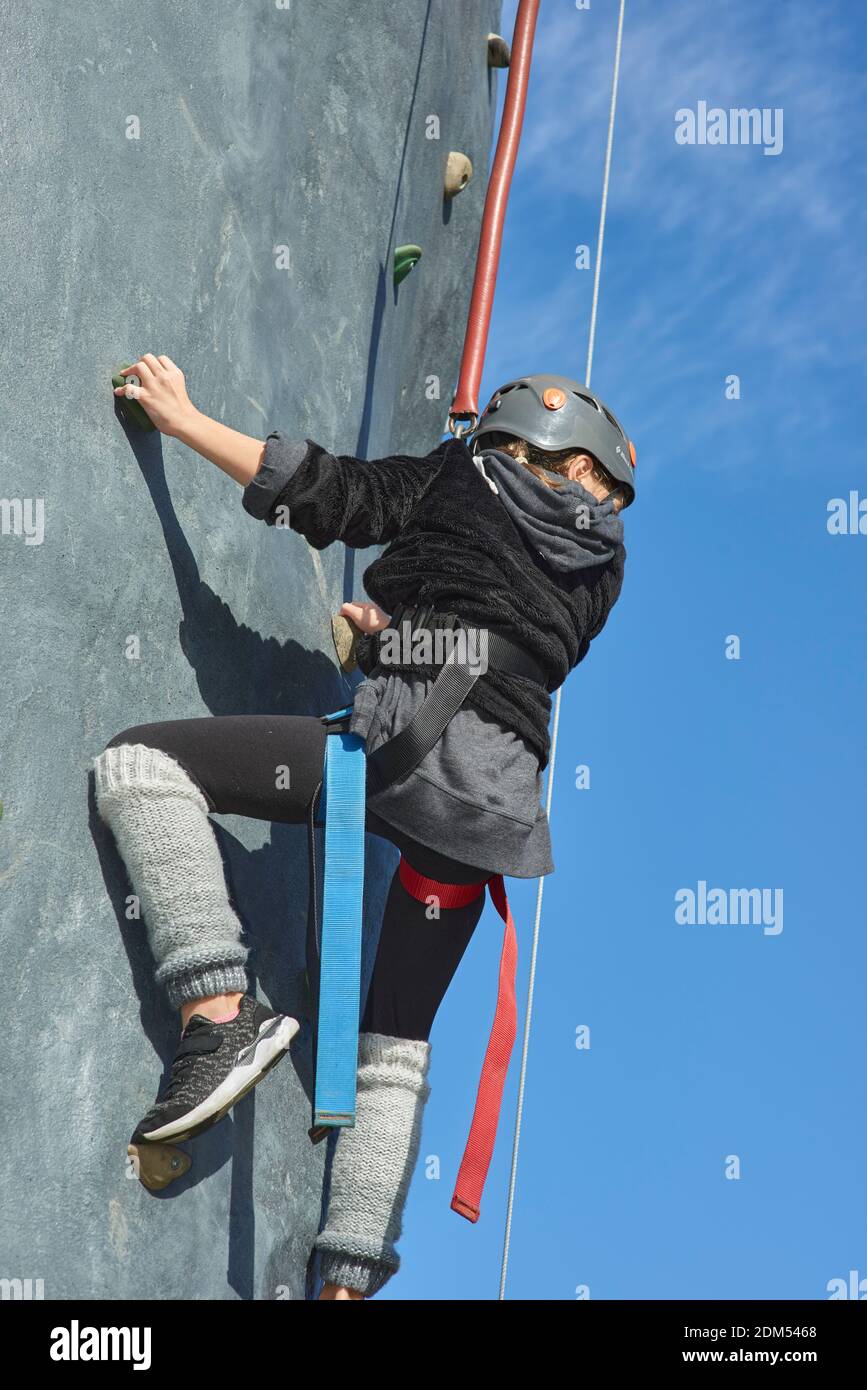 girl almost to top of climbing tower Stock Photo Alamy