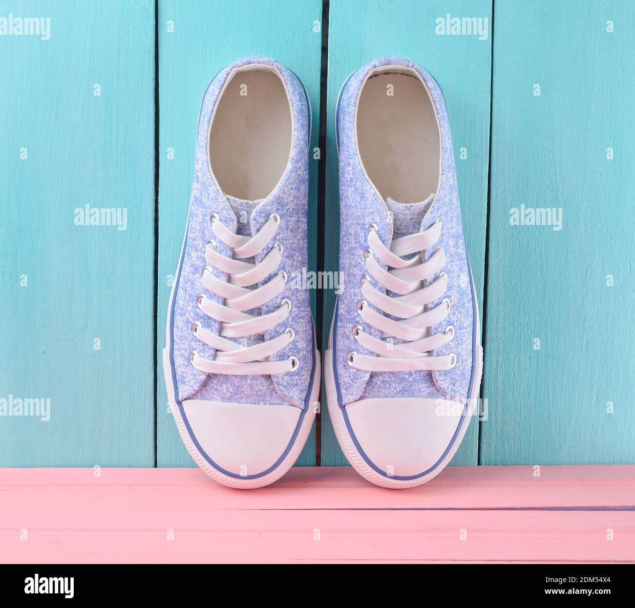 Women's retro hipster sneakers with white laces on a pink wooden floor ...