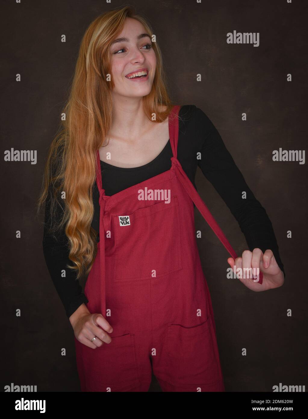 A beautiful natural young women with long blonde hair dressed in red ...