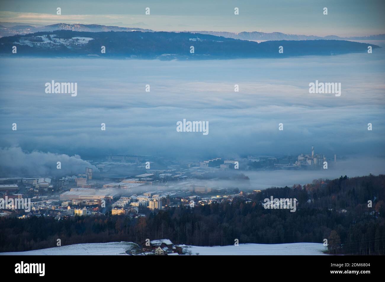 morning mood in a swiss village, the fog envelops the houses, the fog engulfs part of hinwil zurich oberland Stock Photo