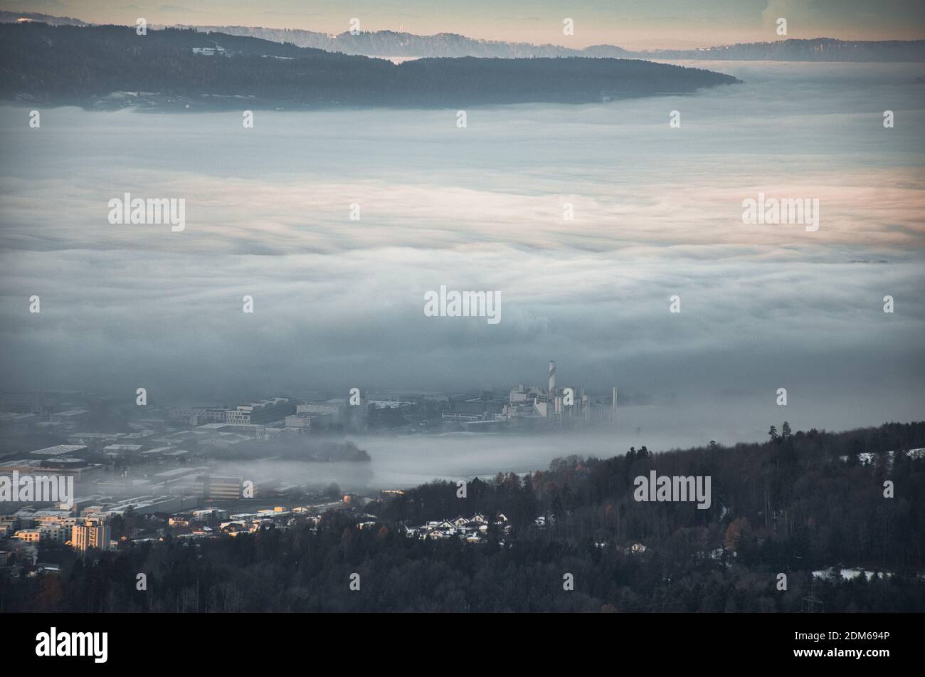 morning mood in a swiss village, the fog envelops the houses, the fog engulfs part of hinwil zurich oberland Stock Photo