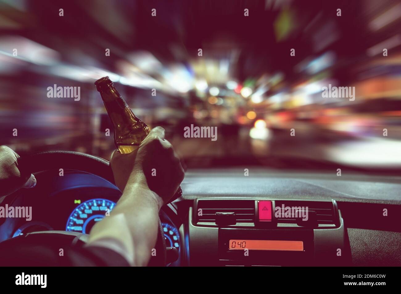 Close Up Of Hand Holding Beer Bottle While Driving Car At Night Stock Photo Alamy