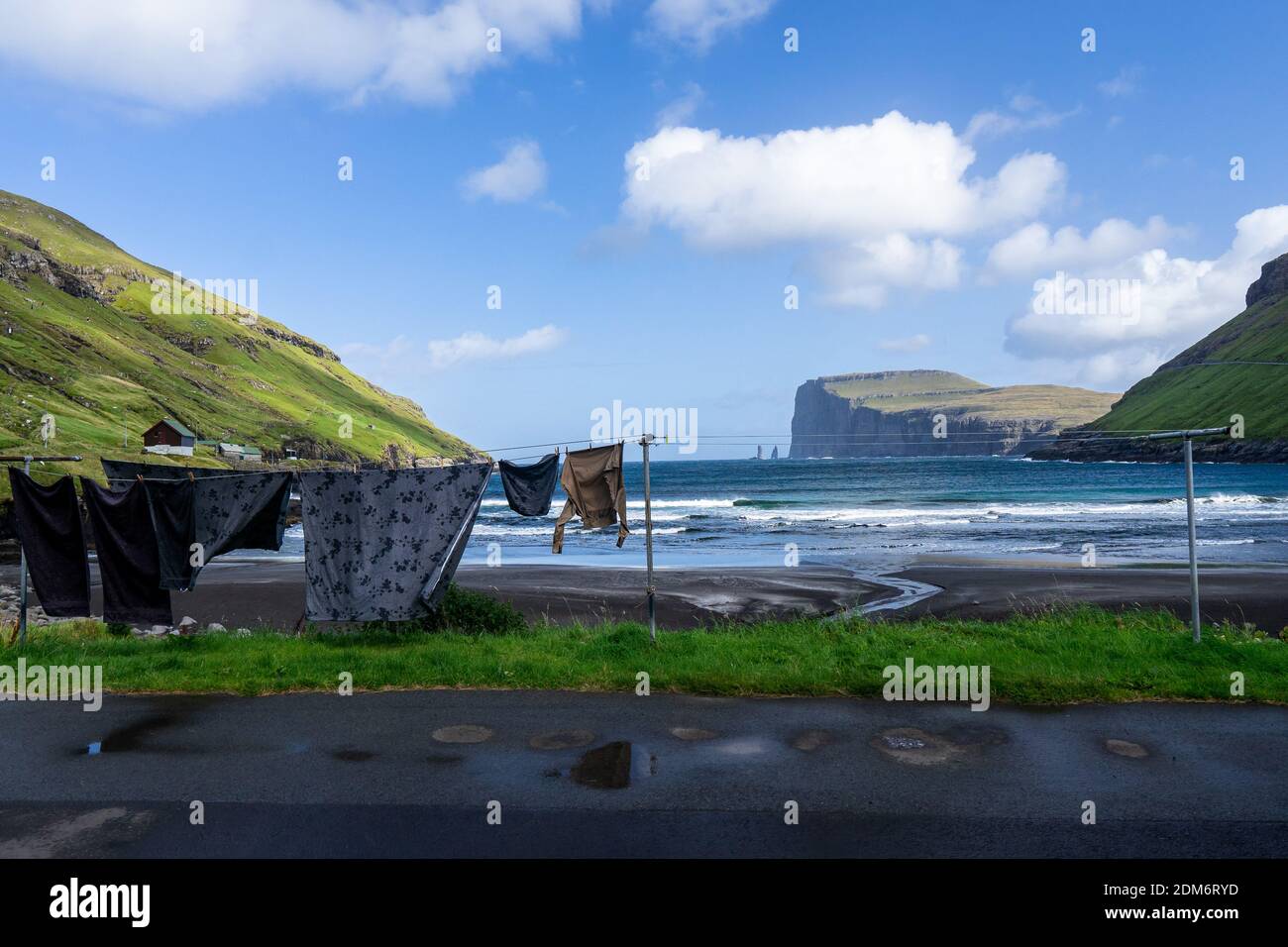 Viðareiði on Viðoy Island, Norðoyar Region, Faroe Island: Clean laundry hanging on a washing lines in a scenic place rounded by mountains. Stock Photo