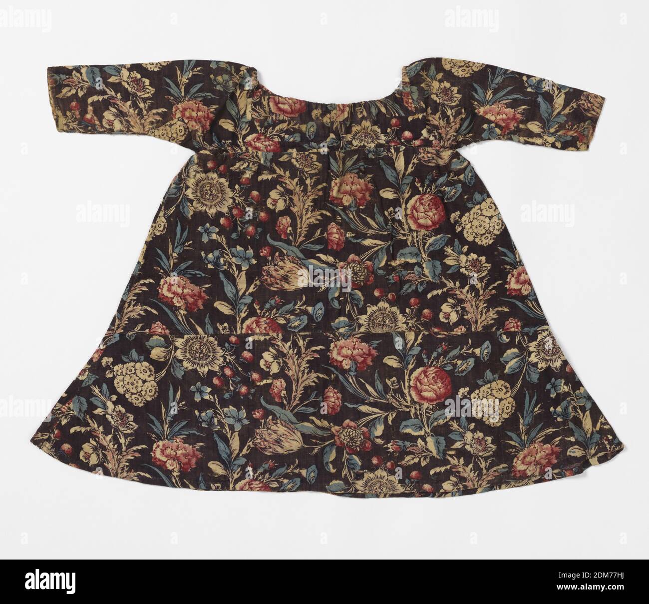 Child's dress, Medium: cotton Technique: block printed on plain weave, Child's dress with drawstrings around neck and chest, made up of pieces of printed cotton with dark brown groun and large-scale flowers and leaves, in red and blue, with traces of yellow., England, USA, late 18th–mid-19th century, costume & accessories, Child's dress Stock Photo