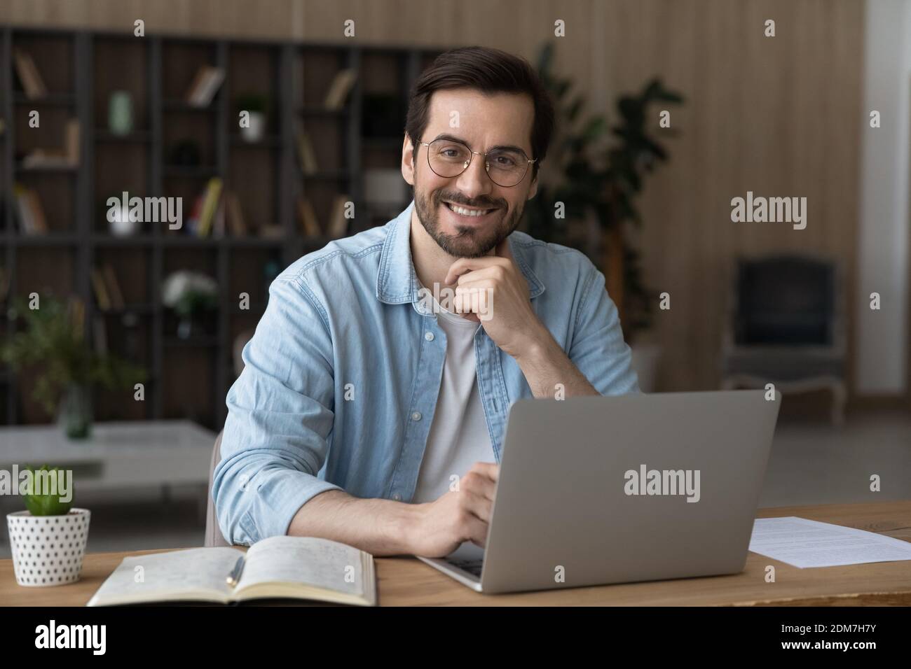 Portrait of happy young man work on laptop Stock Photo