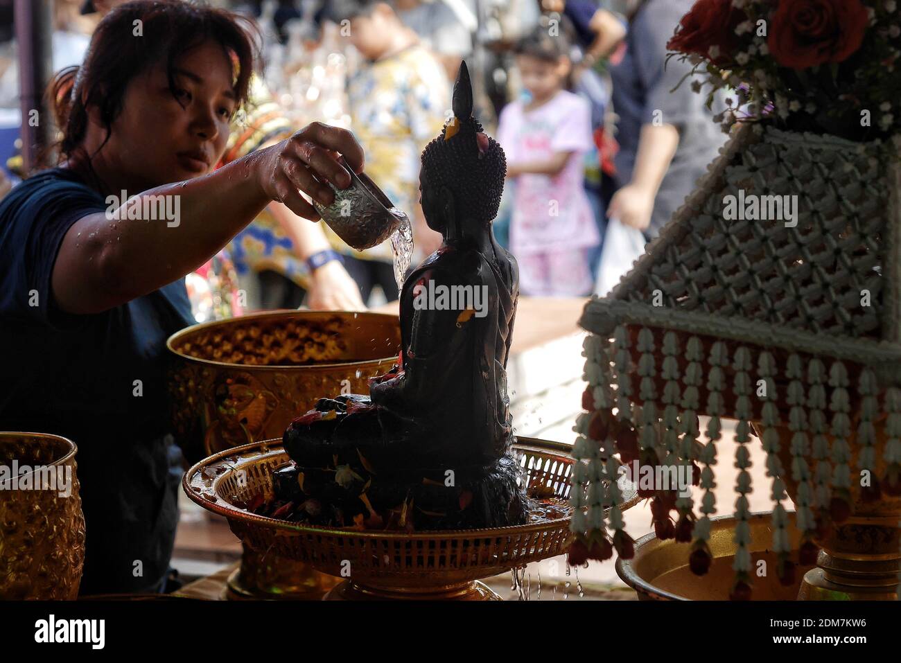 Woman Pouring Water On Buddha Statue Stock Photo - Alamy