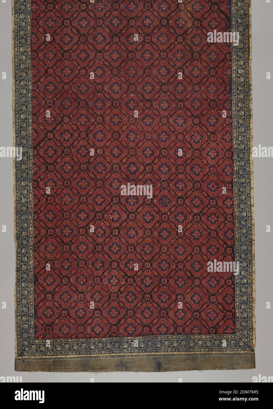 Sarong, Medium: cotton Technique: wax resist dyeing (batik) on plain weave, Red and blue batik sarong. Shows 'ceplokkan' pattern: flowers or blossoms, symmetrically distributed over surface, stylized, star-like,and contained within a geometric shape. Borders show batiked on fringe., Palembang, South Sumatra, Indonesia, 19th century, printed, dyed & painted textiles, Sarong Stock Photo