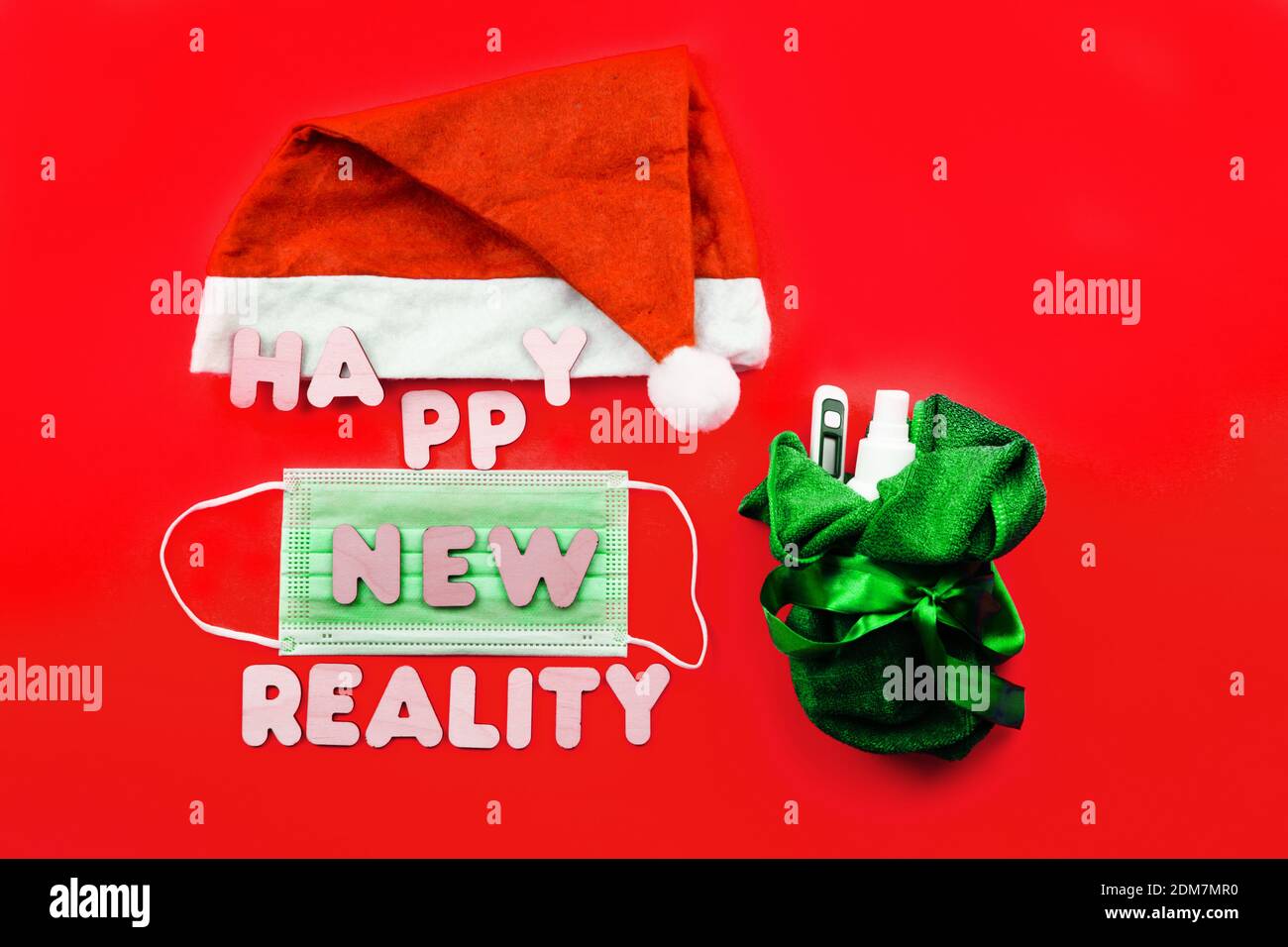 https://c8.alamy.com/comp/2DM7MR0/santa-hat-protective-face-mask-and-wooden-letters-happy-new-reality-on-red-background-christmas-and-new-year-during-epidemic-concept-2DM7MR0.jpg