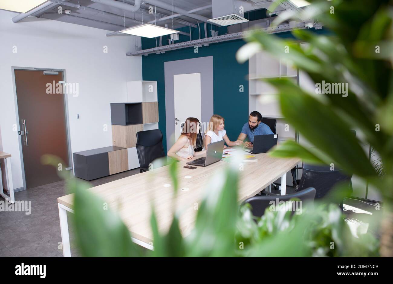 Young entrepreneurs having business meeting at open space office Stock Photo